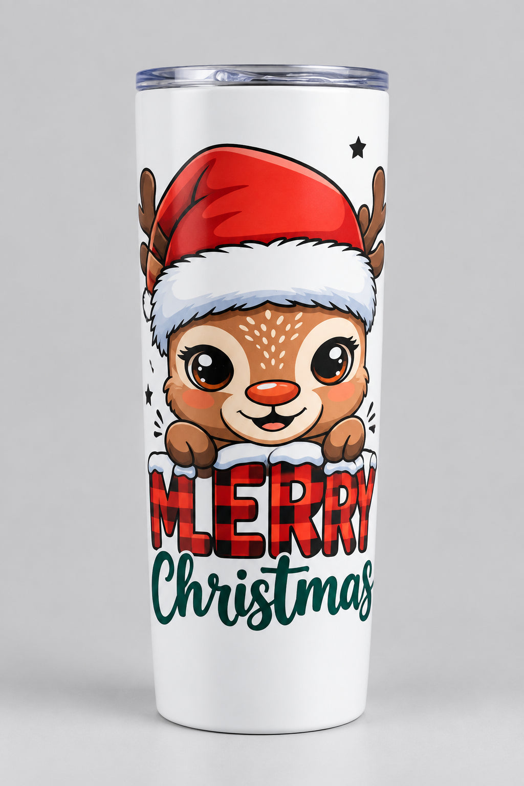 A white tumbler with a clear lid, featuring a cartoon deer wearing a Santa hat and the words 'Merry Christmas' printed on the front, set against a gray tiled background.