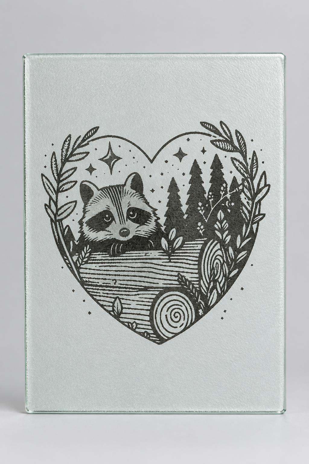 Laser engraved glass cutting board with raccoon heart woodland design - packshot 1